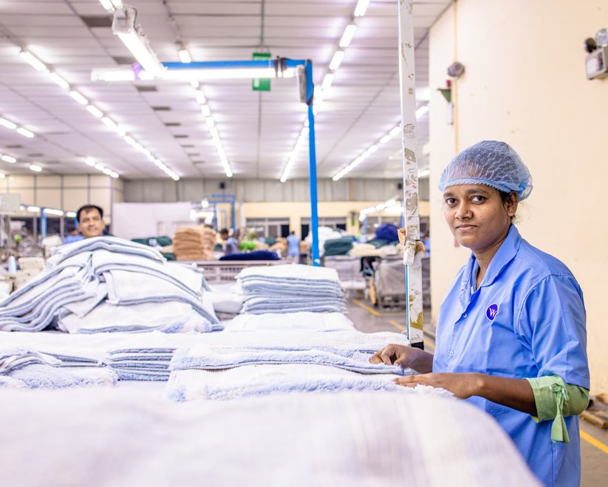 Workers finishing and folding garments on a factory floor